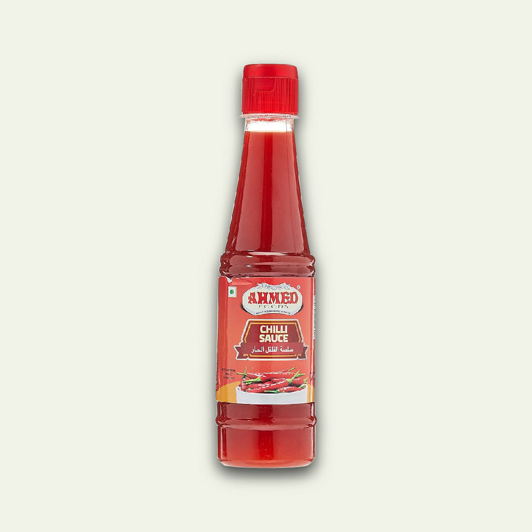 A bottle of Ahmed Chilli Sauce with a red label and red cap, standing upright against a white background.