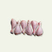 Five raw chicken legs on a light gray background