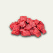 Raw beef chunks on a light gray background